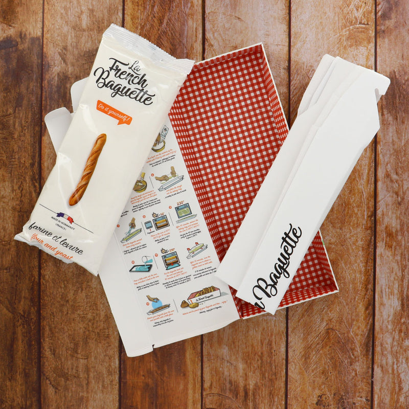 La French Baguette in its Box on Wood Table